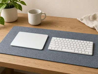 Illustration of a white wireless trackpad next to a keyboard on a modern desk